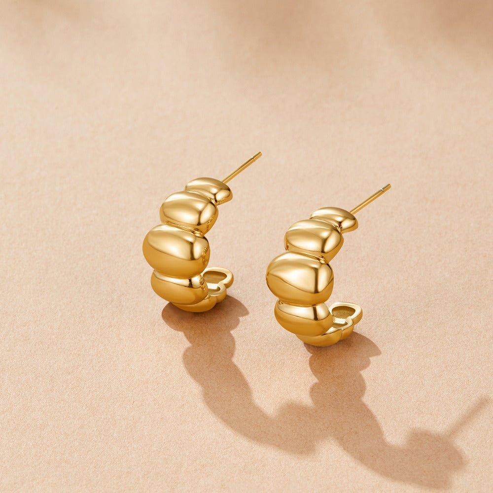 Boucles d’oreilles dorées bombées Rene