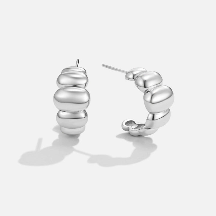 Boucles d’oreilles argentées bombées Rene